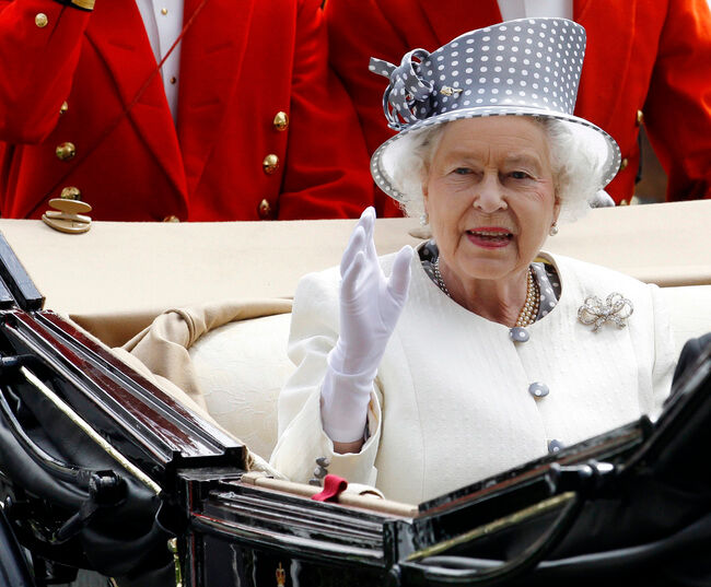 Britain's Queen Elizabeth waves as she arrives on the fifth day of racing at Royal Ascot in southern England